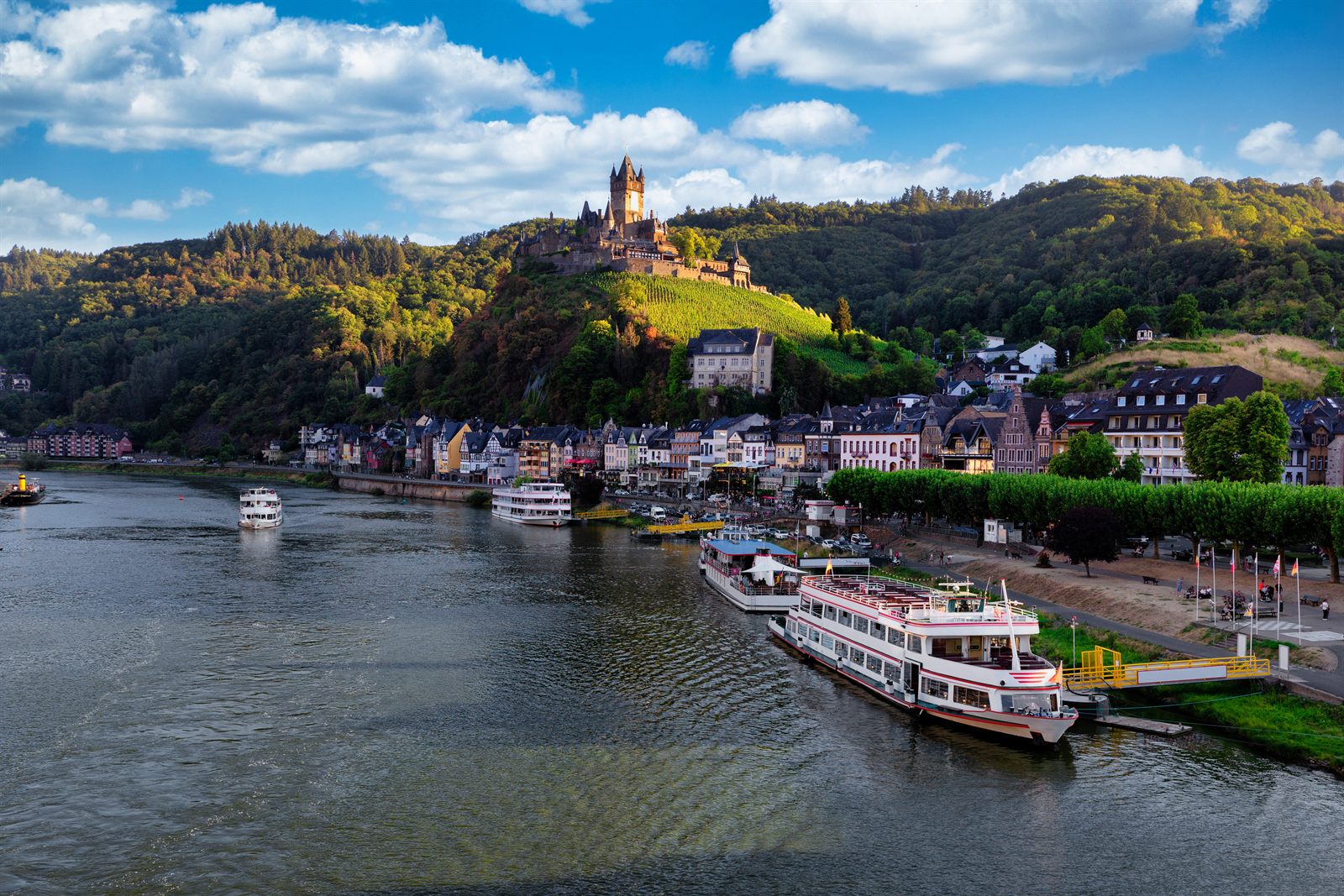 River cruise ship docked at Cochem on the Moselle below Reichsburg Castle