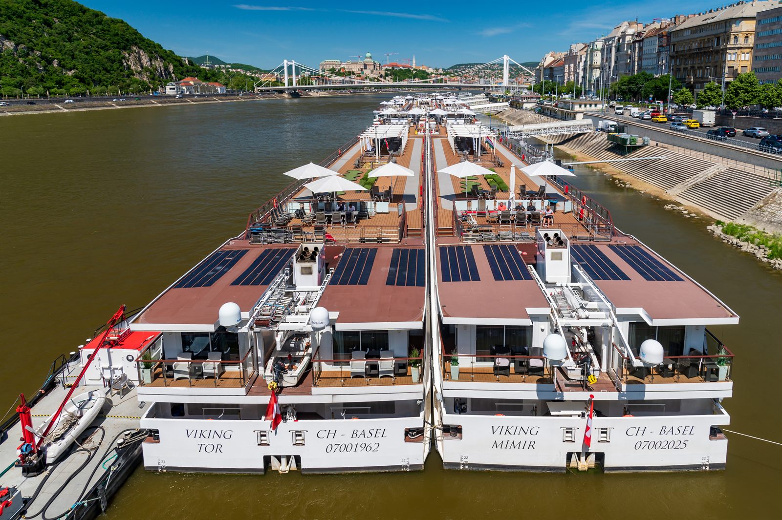 Two river cruise ships side by side showing their sun decks from above